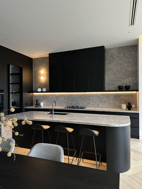 Black kitchen with LED strip lighting under the shelf, downlights and wall lights